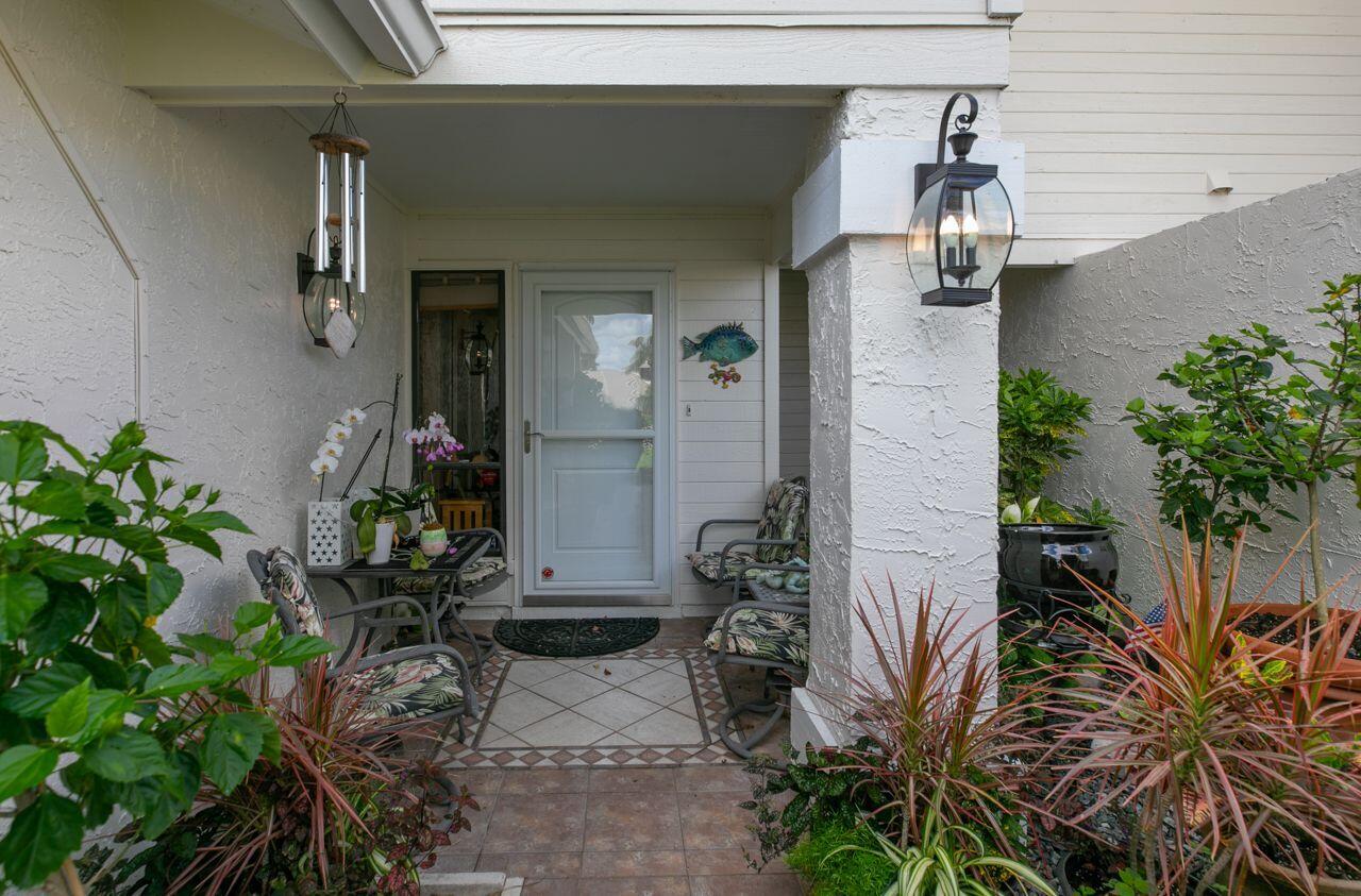 5606 Southeast Foxcross Place Stuart, FL 34997 - Photo 7 of 65 a potted plant sitting in front of a house