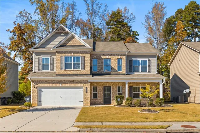 a front view of a house with a yard