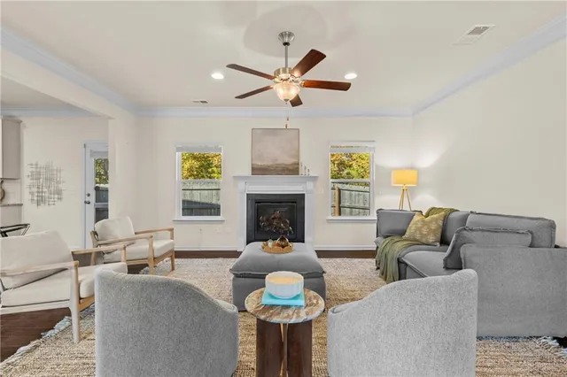 a living room with furniture a fireplace and a chandelier