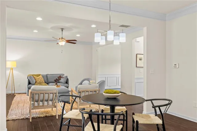 a view of a dining room with furniture and wooden floor