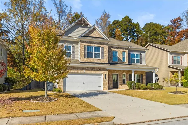 a front view of a house with garden