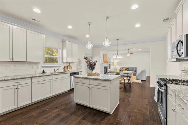 a kitchen with sink stove and cabinets