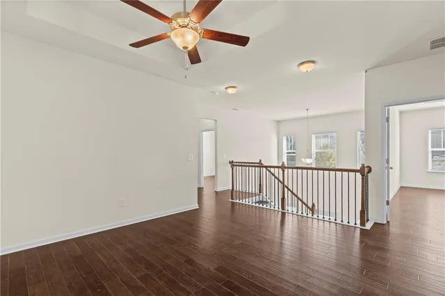 a very nice looking room with wooden floor and white walls