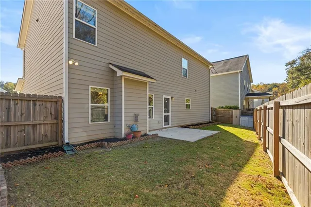 a view of a yard with wooden fence