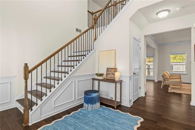 a view of entryway and hall with wooden floor