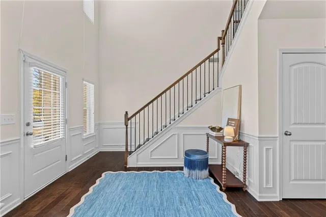 a view of entryway with wooden floor and stairs