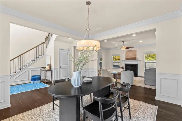 a view of a dining room with furniture wooden floor and chandelier