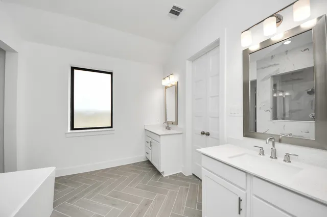 a bathroom with a bathtub and a sink