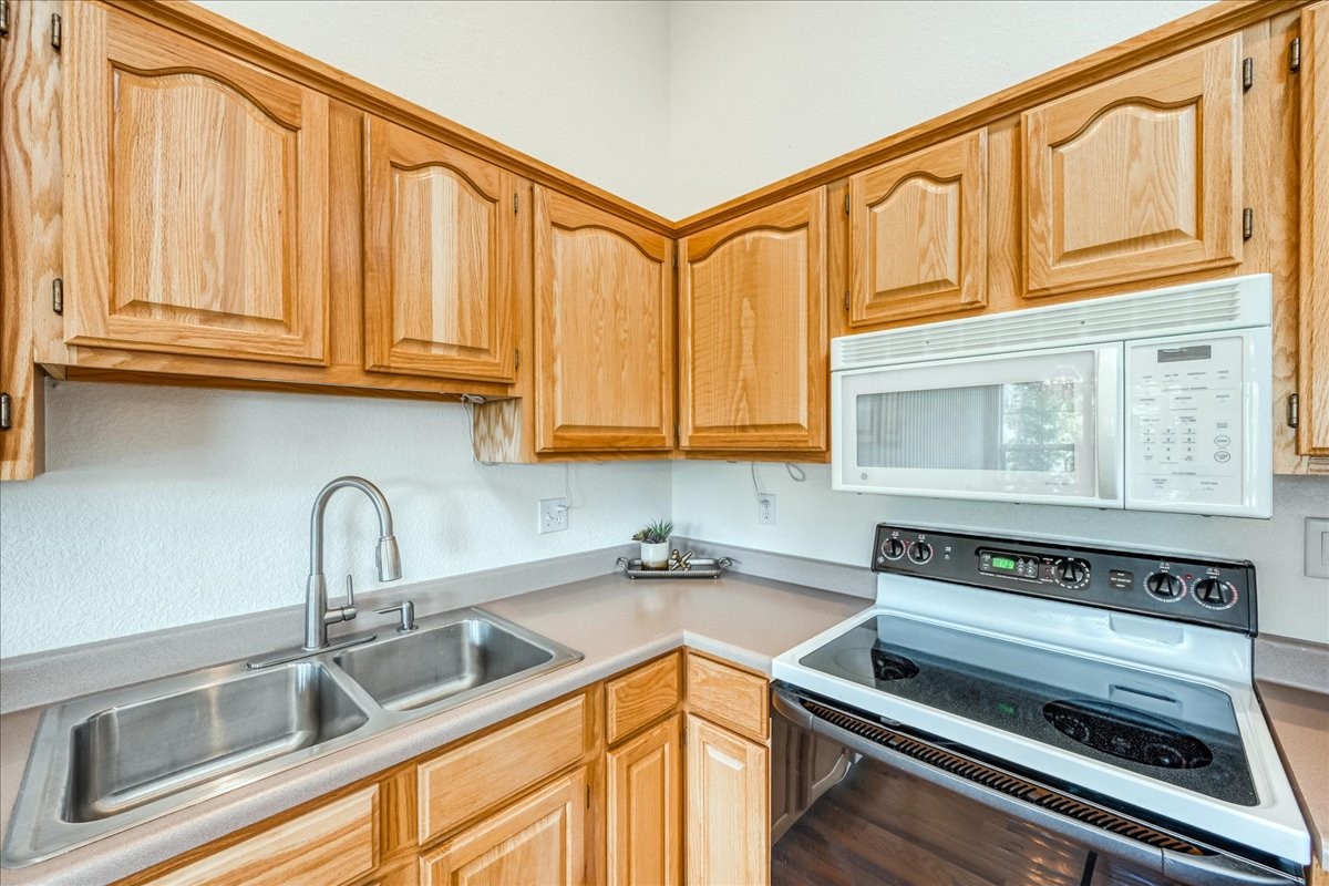 91399 Ryan Gulch Road, Unit B6 Silverthorne, CO 80498 - Photo 12 of 36 a kitchen with stainless steel appliances granite countertop a sink and cabinets