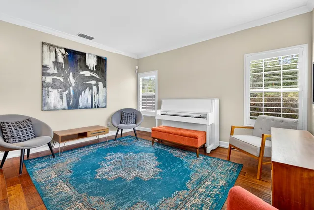 a view of a dining room with furniture wooden floor and a chandelier