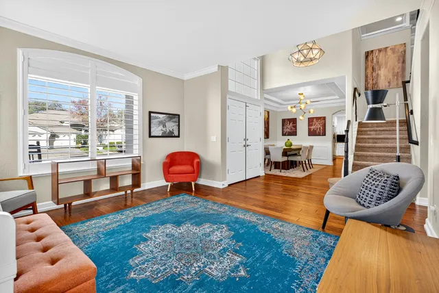 a view of a dining room with furniture and wooden floor