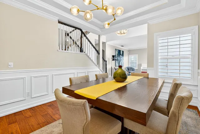 a kitchen with stainless steel appliances granite countertop a refrigerator a stove and white cabinets