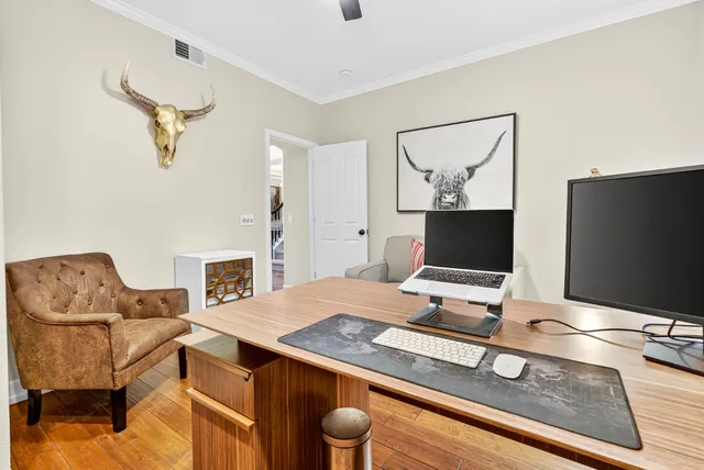 a view of a dining room with furniture wooden floor and chandelier