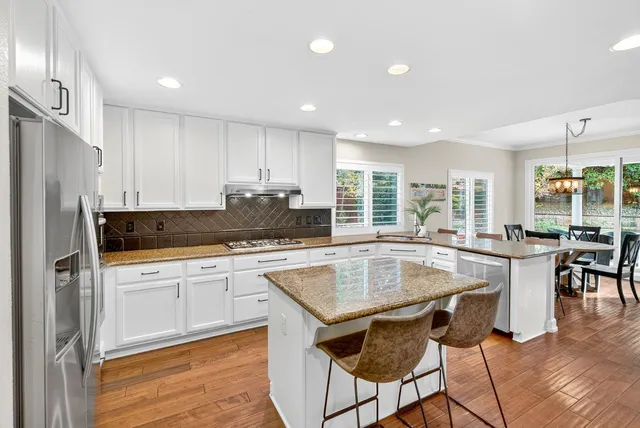 a spacious bedroom with a bed and a lamp