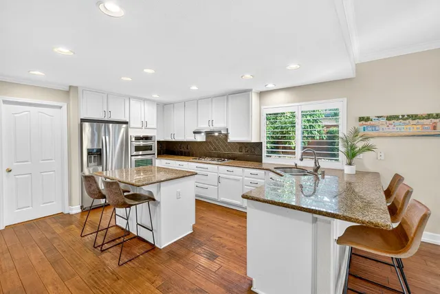 a spacious bedroom with a bed and a flat screen tv