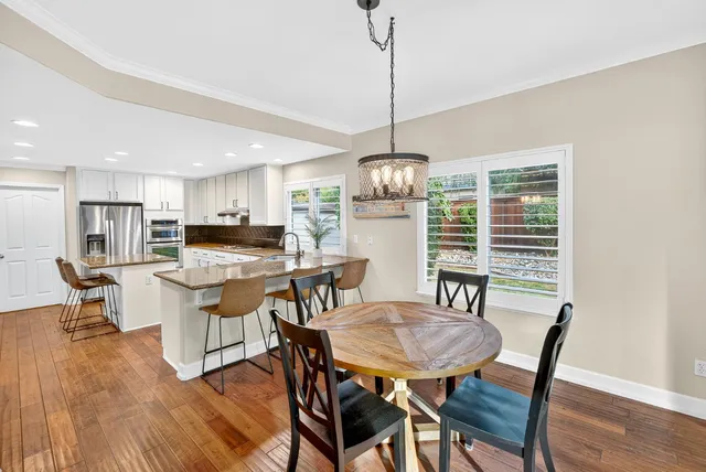 a bedroom with two beds and painting on the wall