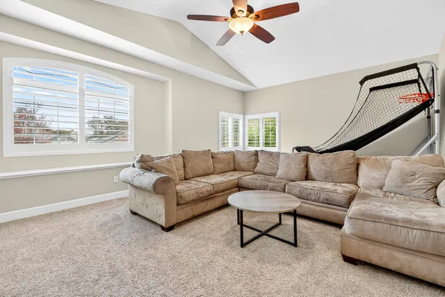 an aerial view of residential houses with outdoor space and a lake view