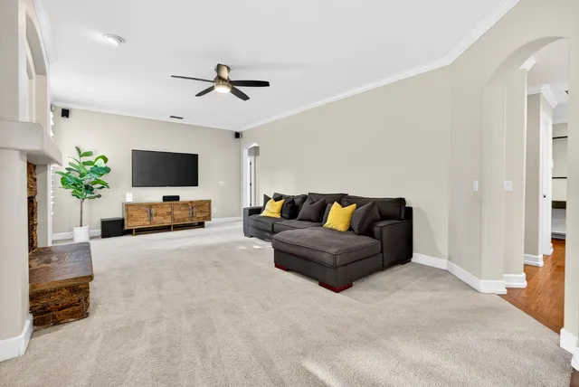 a living room with furniture and a dining table with wooden floor