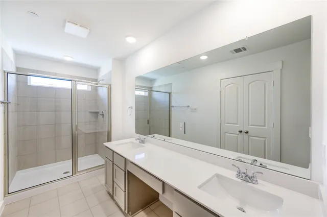 a bathroom with a granite countertop sink a shower and a mirror