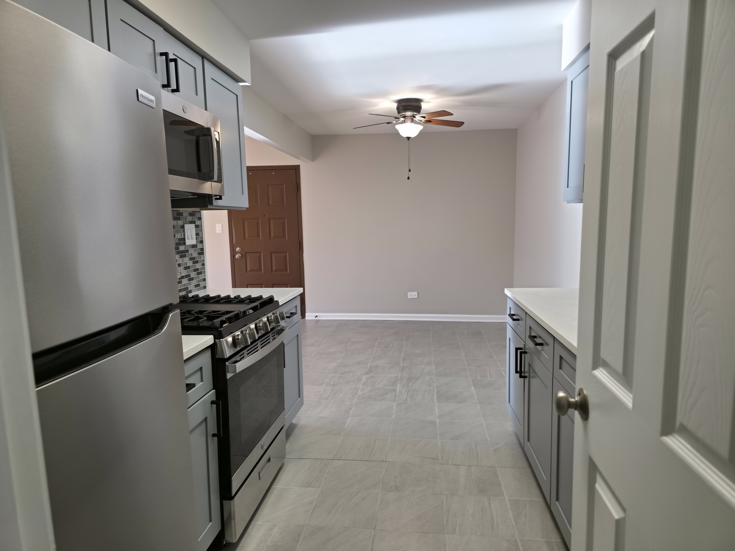 412 East Bailey Road, Unit 104 Naperville, IL 60565 - Photo 4 of 11 a kitchen with stainless steel appliances granite countertop a refrigerator and a stove top oven