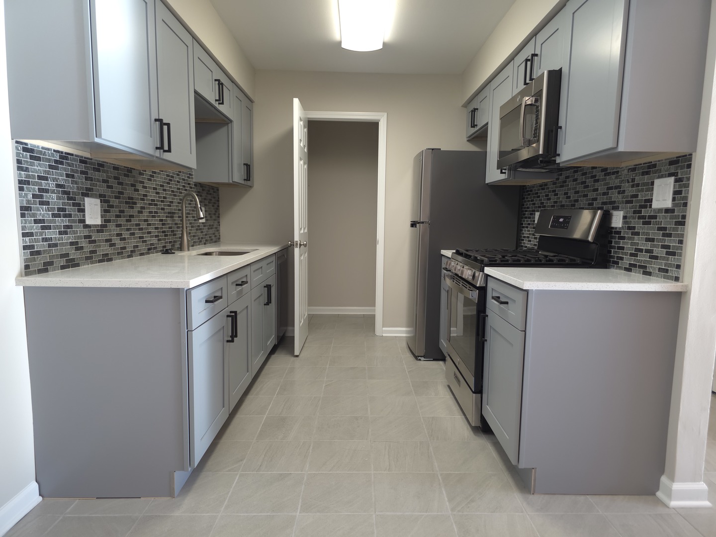 412 East Bailey Road, Unit 104 Naperville, IL 60565 - Photo 6 of 11 a kitchen with stainless steel appliances granite countertop a stove a sink and a refrigerator