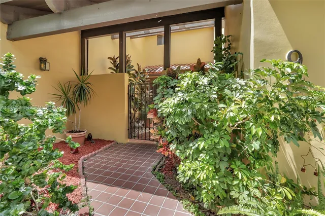 a plant is in front of a glass door