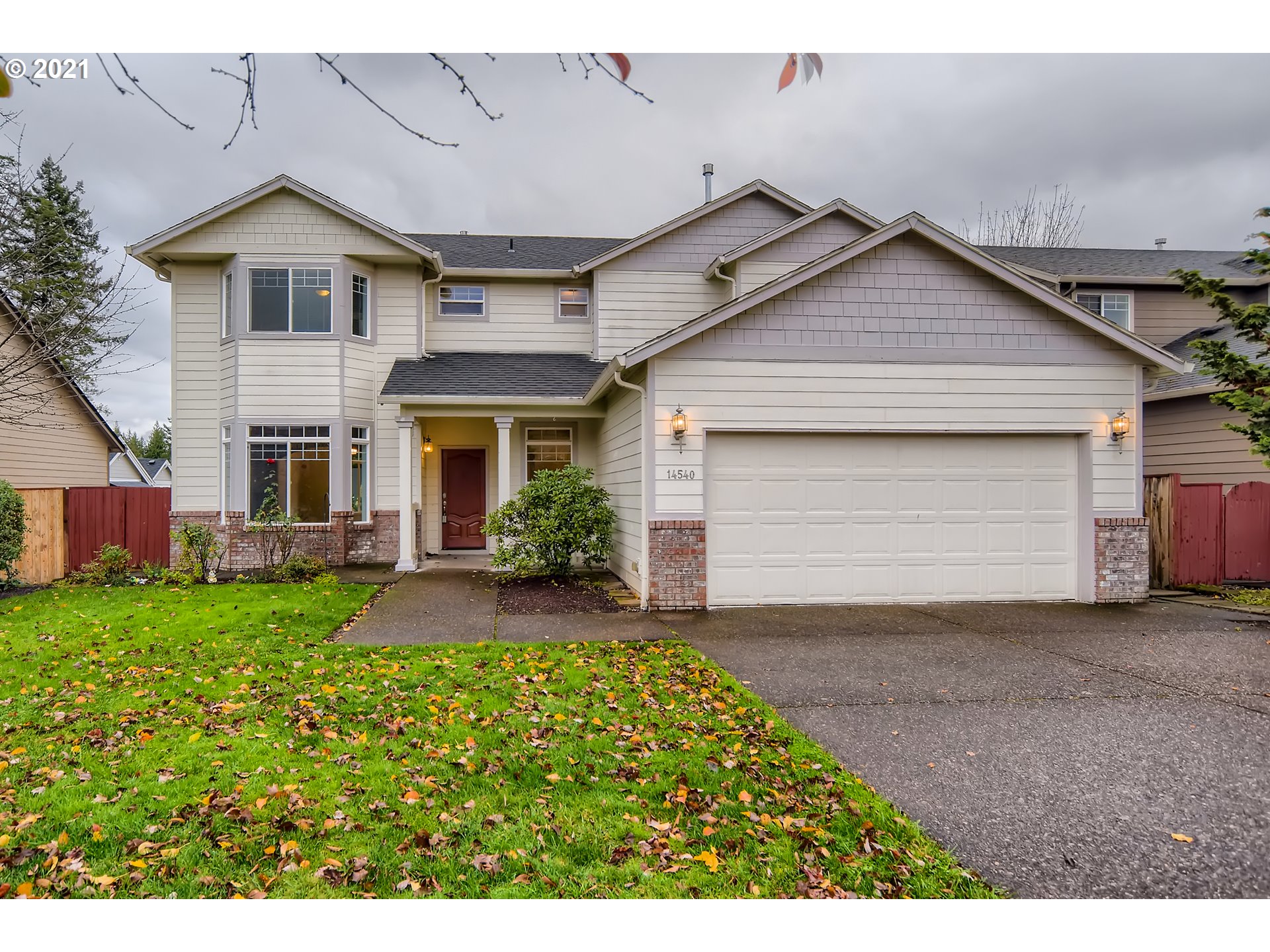 a front view of a house with a yard and garage