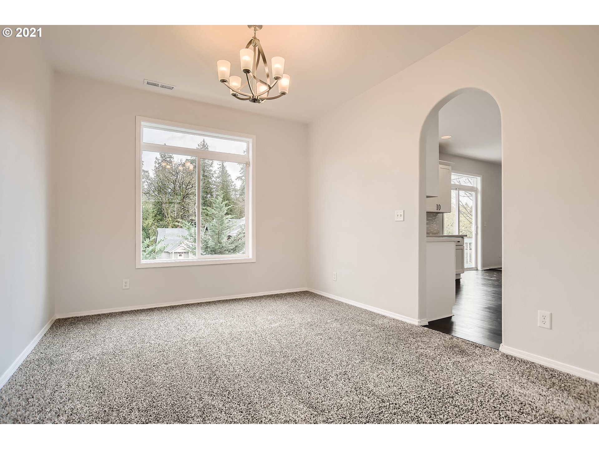 14540 Southeast Marci Way Clackamas, OR 97015 - Photo 7 of 32 an empty room with a window and chandelier