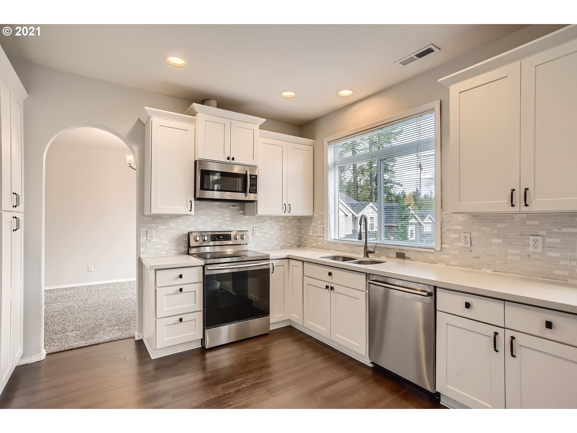 14540 Southeast Marci Way Clackamas, OR 97015 - Photo 9 of 32 a kitchen with stainless steel appliances granite countertop a stove top oven a sink dishwasher a refrigerator and a microwave