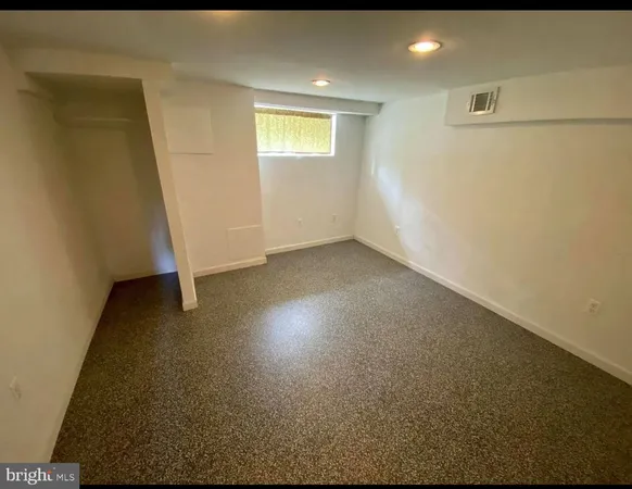 a view of a room with water heater and wooden cabinets
