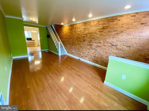 a view of a room with wooden floor