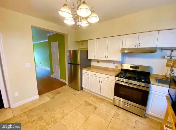 a kitchen with cabinets and stainless steel appliances