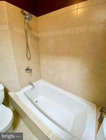 a view of room and hall with wooden floor