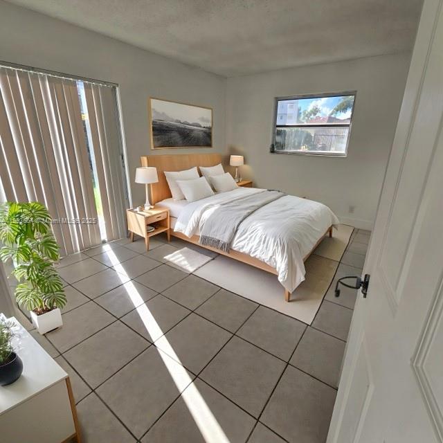 Lakeshore at University Park Miramar, FL 33025 - Photo 6 of 10 a bedroom with a bed and a painting on the wall