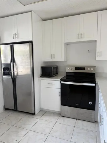 a kitchen with cabinets and steel stainless steel appliances