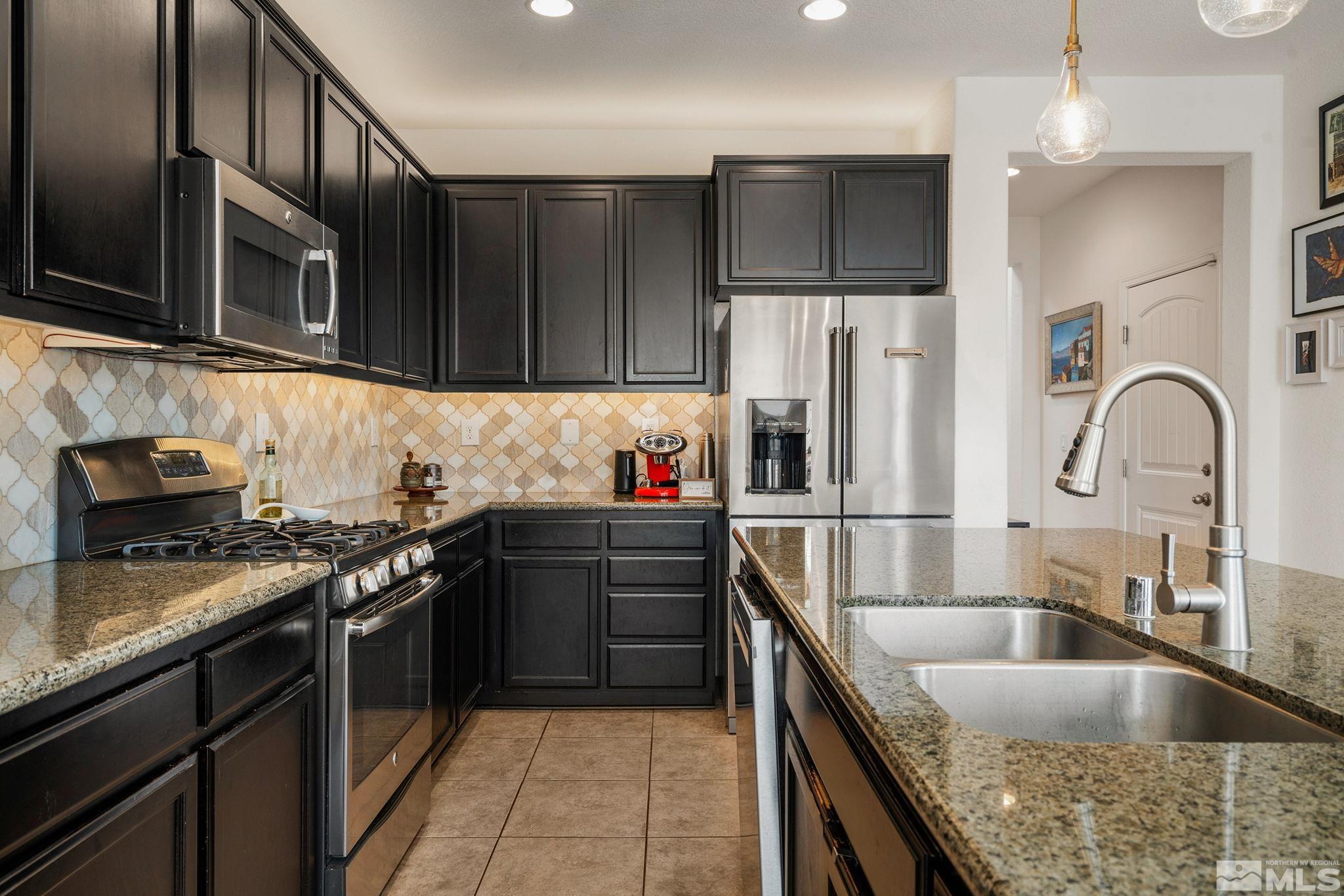 1950 Hope Valley Drive Reno, NV 89521 - Photo 11 of 32 a kitchen with stainless steel appliances granite countertop a sink stove and refrigerator