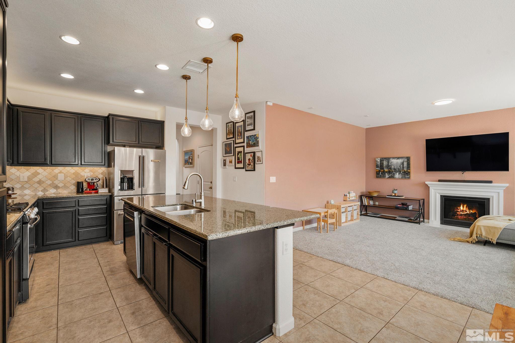 1950 Hope Valley Drive Reno, NV 89521 - Photo 12 of 32 a kitchen with stainless steel appliances granite countertop a sink counter space cabinets and a stove