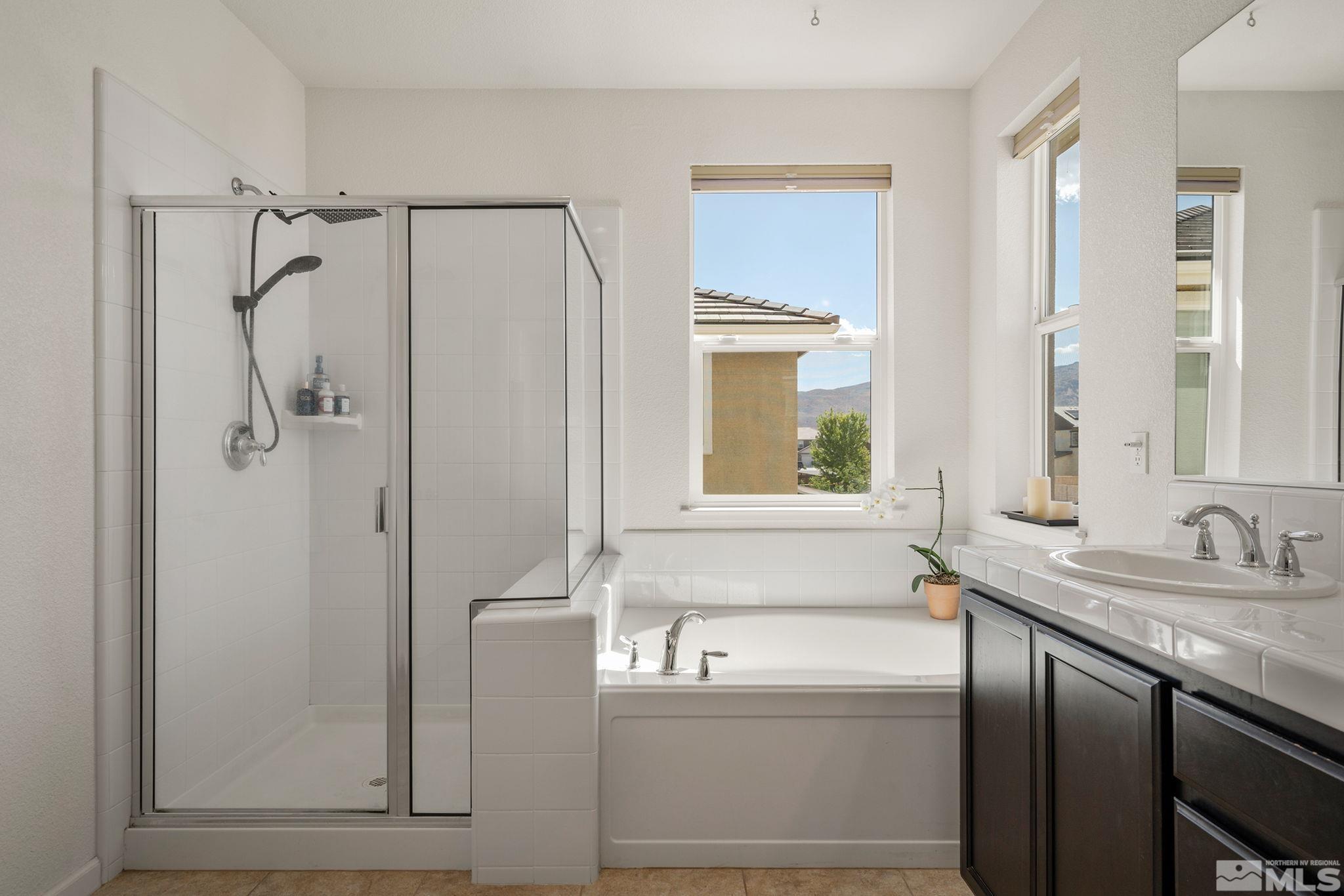 1950 Hope Valley Drive Reno, NV 89521 - Photo 19 of 32 a bathroom with a granite countertop sink mirror and a bathtub