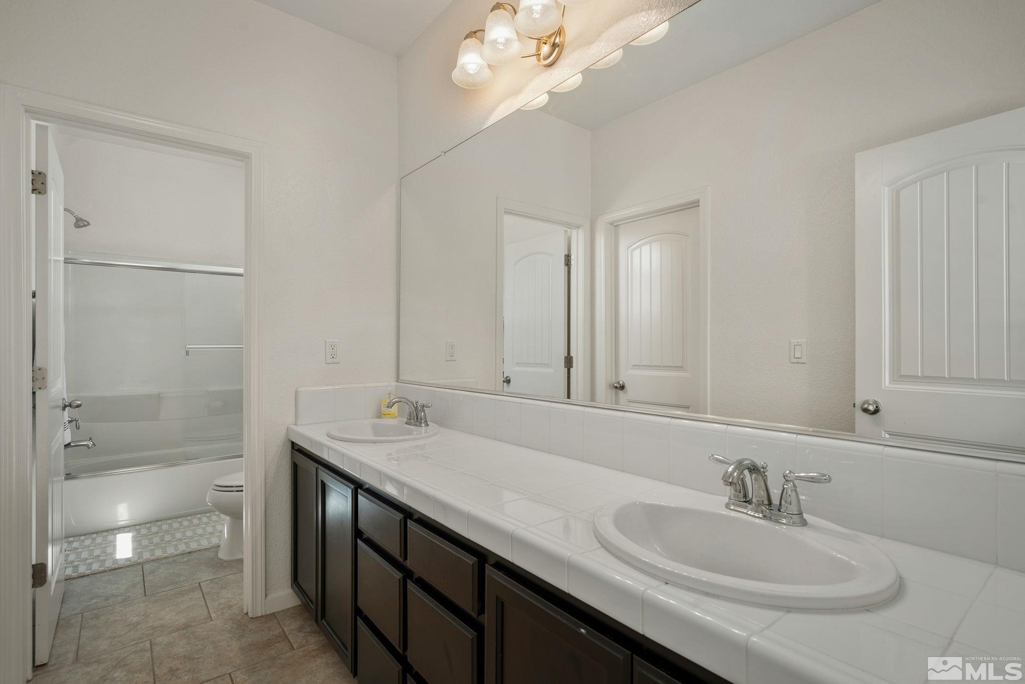 1950 Hope Valley Drive Reno, NV 89521 - Photo 22 of 32 a bathroom with a sink double vanity and a mirror