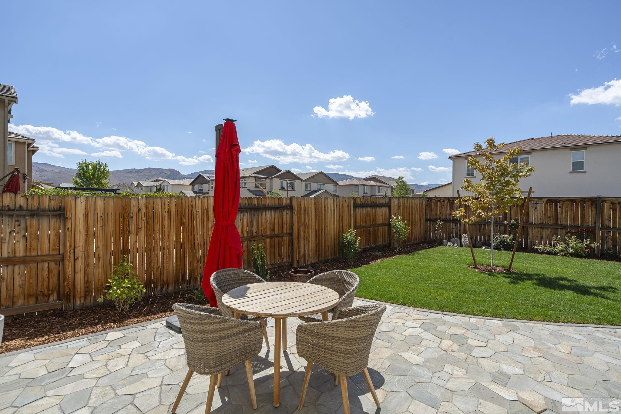 1950 Hope Valley Drive Reno, NV 89521 - Photo 24 of 32 a view of a backyard with table and chairs a barbeque grill with wooden fence