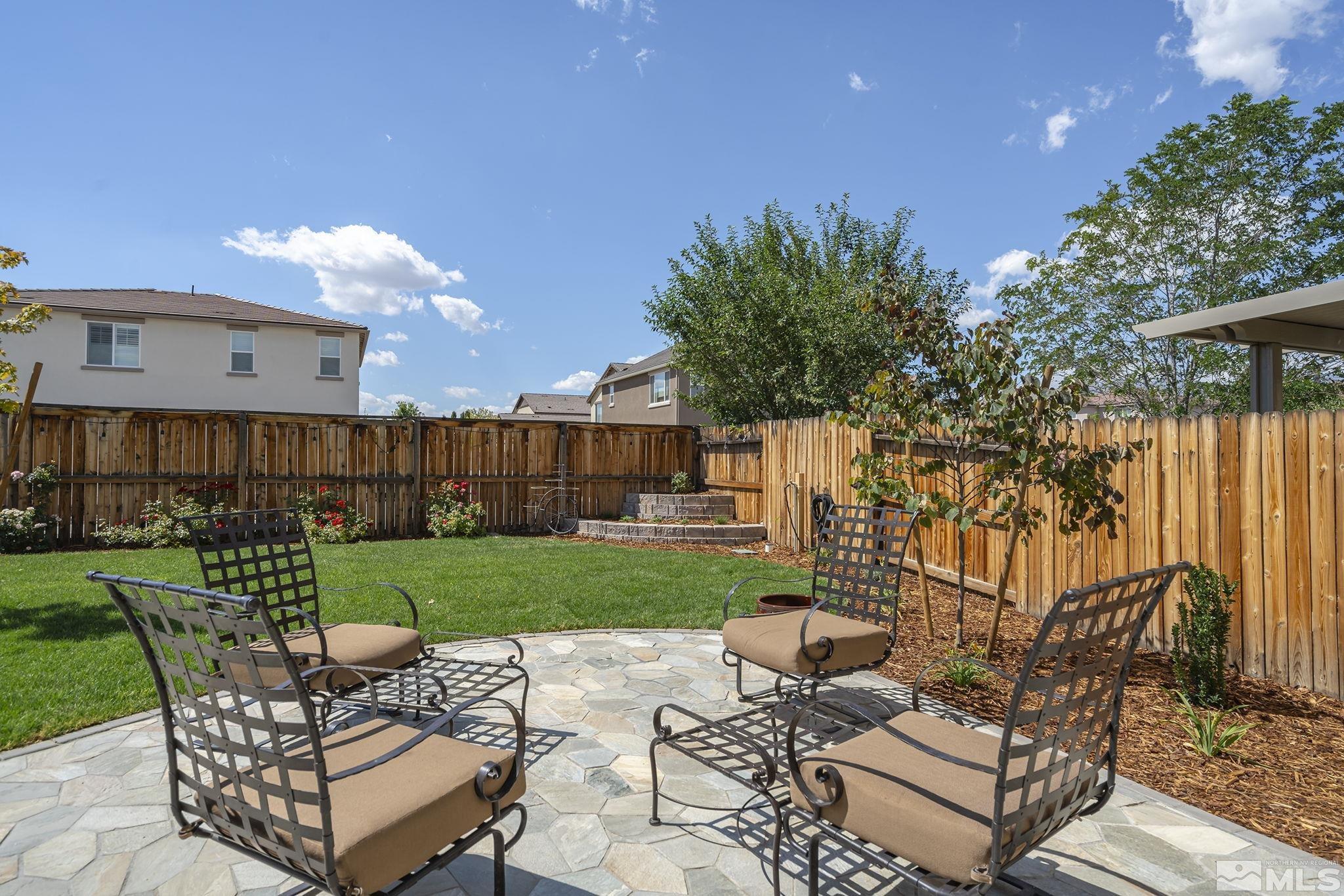 1950 Hope Valley Drive Reno, NV 89521 - Photo 26 of 32 a view of a backyard with couches plants and large tree