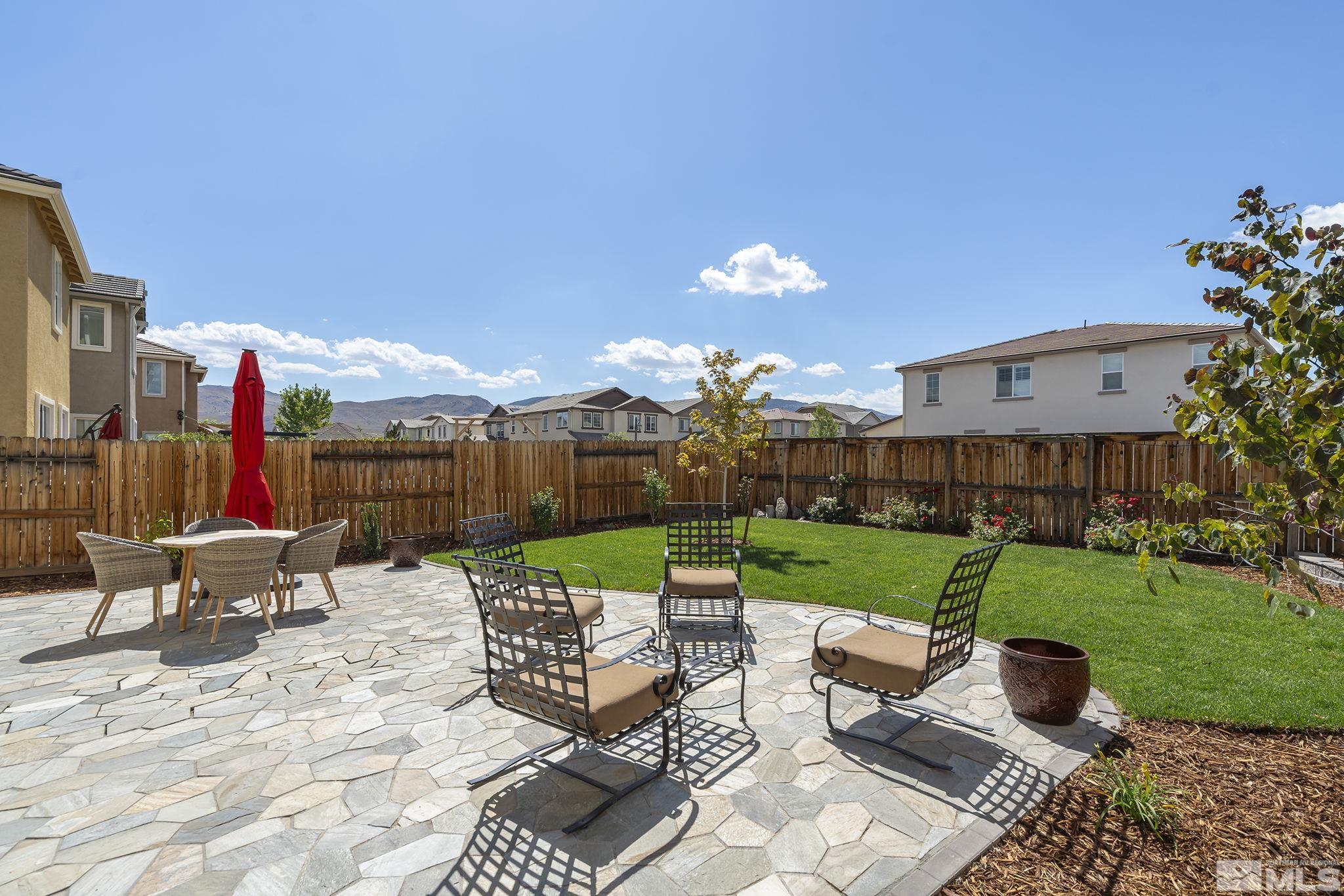 1950 Hope Valley Drive Reno, NV 89521 - Photo 27 of 32 a view of a patio with table and chairs potted plants and a big yard