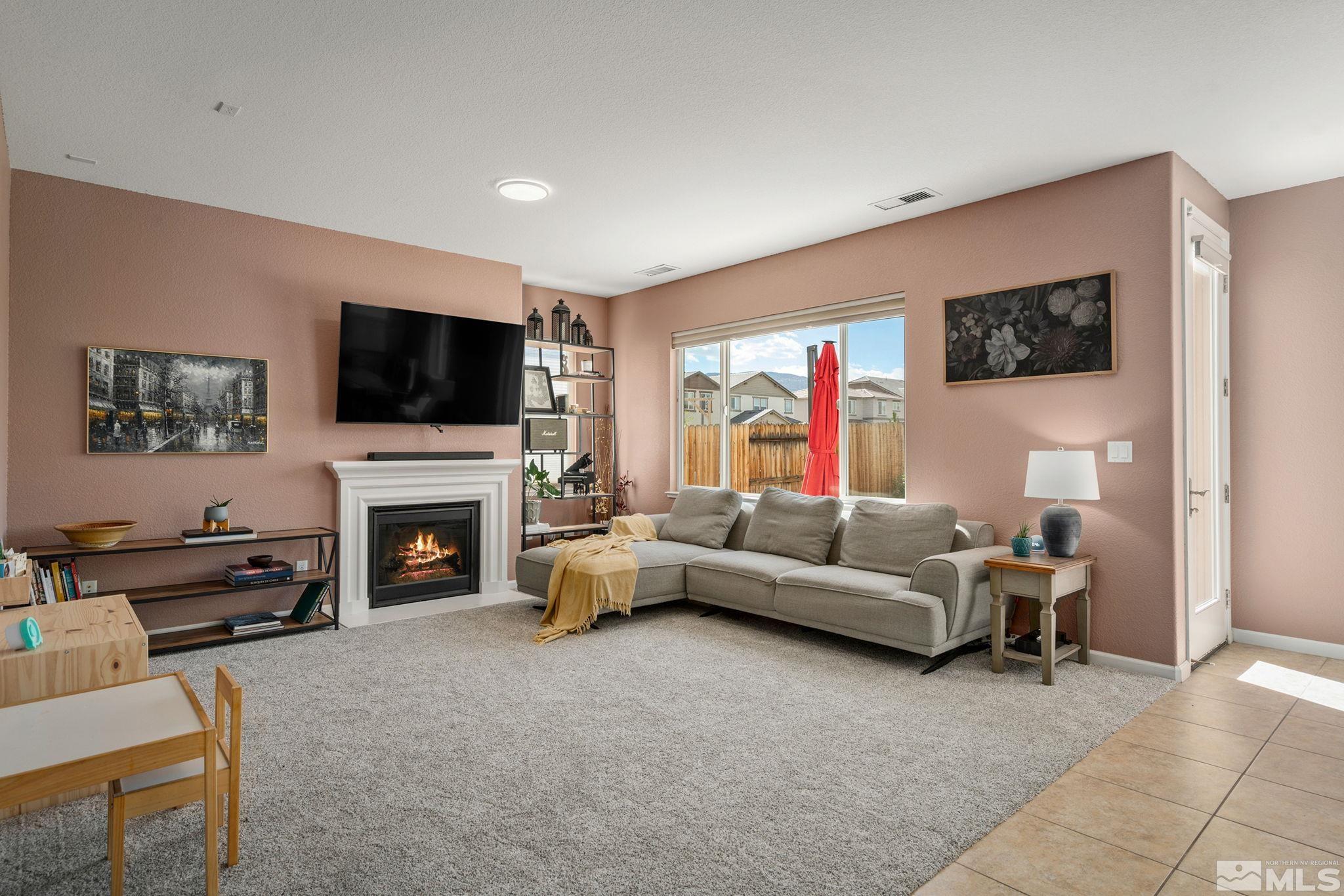 1950 Hope Valley Drive Reno, NV 89521 - Photo 6 of 32 a living room with furniture a flat screen tv and a fireplace
