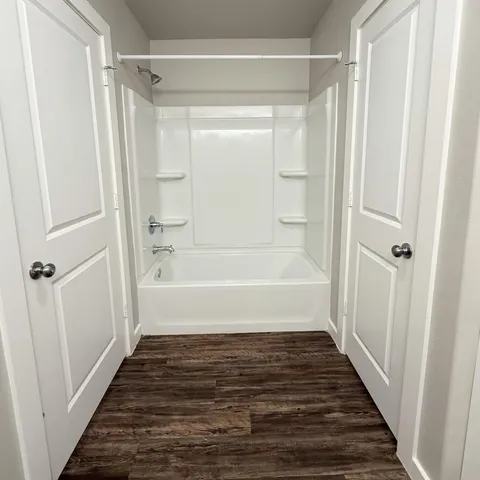 a bathroom with a bathtub and a shower