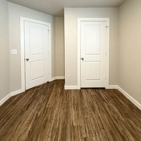 a view of a room with wooden floor and closet