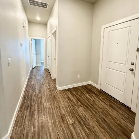 a view of a room with wooden floor and closet