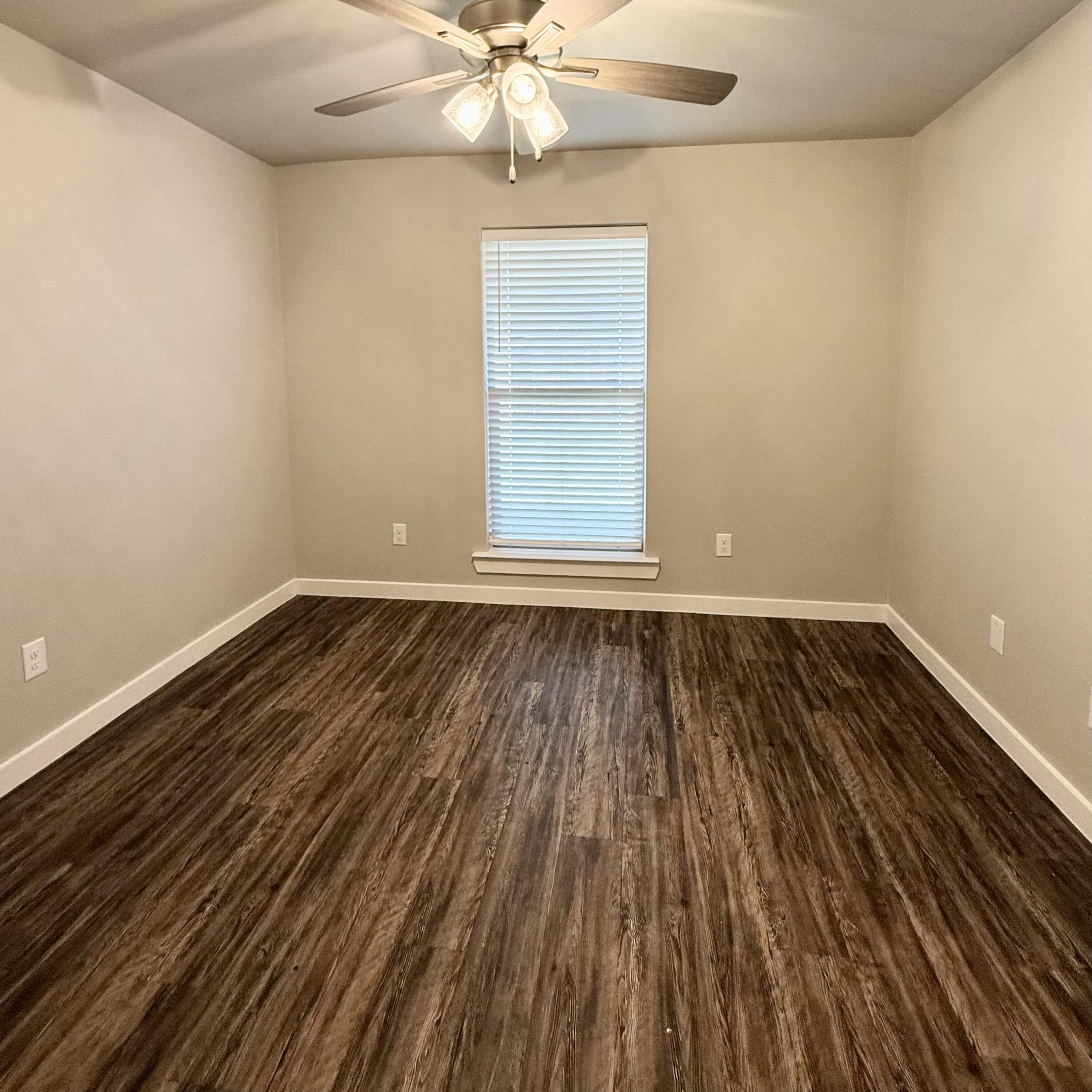 2108 North Jayton Avenue, Unit A Lubbock, TX 79403 - Photo 9 of 17 a view of room with wooden floor and ceiling fan