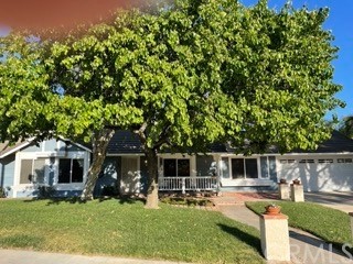 6595 Country Lane Riverside, CA 92505 - Photo 1 of 1 a front view of a house with a yard