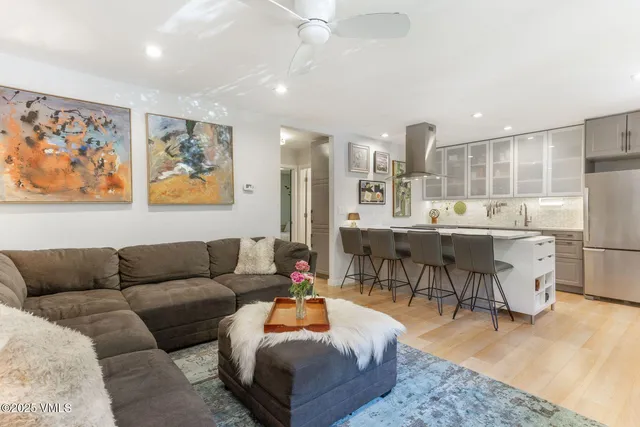 a living room with furniture and kitchen view
