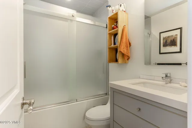 a bathroom with a sink vanity and toilet